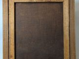 an old wooden picture frame with a black background on a white surface