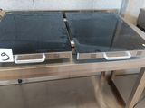 stainless steel counter top with two ovens on each of them