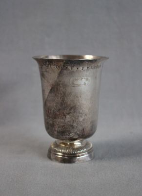a silver cup that is sitting on a table