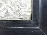a picture of a metal relief of a man on a horse