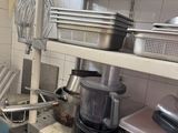 many pots and pans on the shelves in the kitchen