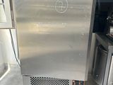 a stainless steel refrigerator sitting in a kitchen next to a stove