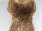 a close up of a wooden object on a white surface