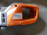 an orange and gray handheld vacuum cleaner sitting on top of a cement floor