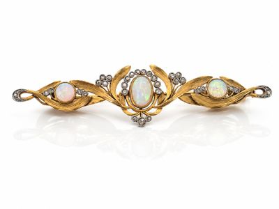 a pair of oplite and diamond broochers