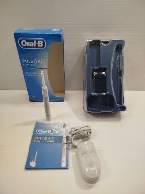 a toothbrush that is sitting on a table next to a box of toothpaste