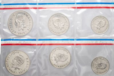 a close up of six quarters of the united states in plastic bags