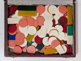 a box full of colorful magnets on a white surface
