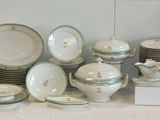 a lot of plates and bowls on the table