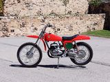 a red dirt bike parked on the side of the road