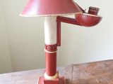 a red lamp that is sitting on a wooden table