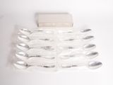 six spoons and a box on a white surface