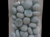 a bag of blue candy sitting on a black surface