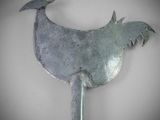 a metal bird that is hanging on the wall