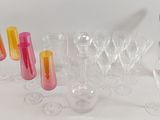a lot of glasses and a silver vase on the table