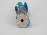 a blue fish that is laying down on a white surface