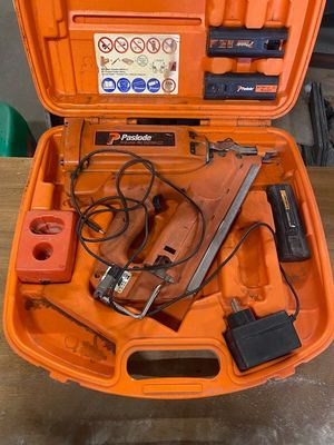 an orange tool case with tools in it on a table