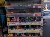 many pens and markers on display in a store