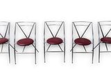 four chairs with red leather seats are lined up against a white background