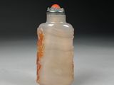 a picture of a glass bottle with an orange flower on it