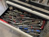 a drawer full of tools in a garage
