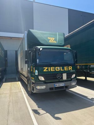 two trucks that are parked next to each other in a parking lot