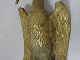 brass statue of a bird with a long neck and large wings