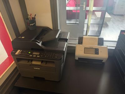 a printer sitting on top of a desk next to a printer