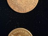 three different types of coins are shown on a black surface