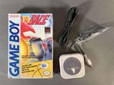 the gameboy is sitting on the table next to the box