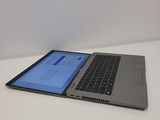 the laptop is open on a white surface with a blue screen