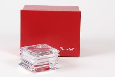 a small red box with a clear glass object in it