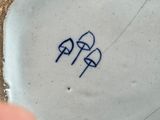 a small plate with a blue and white design on it
