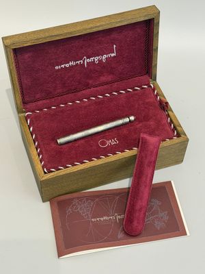 un stylo dans un coffret en bois avec un étui en velours rouge