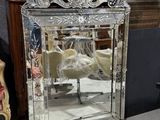 a mirror that is sitting on a table next to a lamp