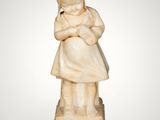 a carved ivory figurine of a woman holding a child