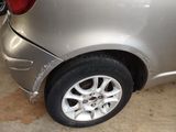 a silver car that has been dented and is parked in a garage