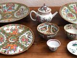 a wooden table with a variety of dishes and cups on it