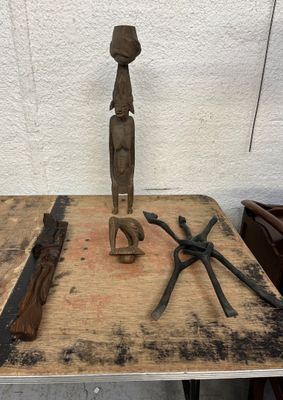 a wooden table with tools on it and a statue on top of it