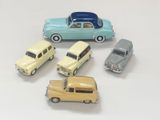 several toy cars are lined up on a white surface
