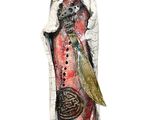 statue of a woman holding a sword and a bird on a stand