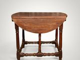 an antique oak drop leaf table with turned legs