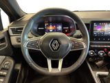 the interior of a car with a steering wheel and dashboard controls