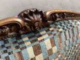 an image of a couch with a blue and brown checkered upholstered