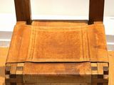 a wooden chair that is sitting on a hard wood floor