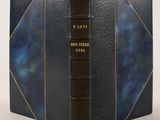 an old book with a blue cover and gold lettering on it