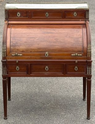 un bureau ancien muni de tiroirs et d'un plateau en marbre