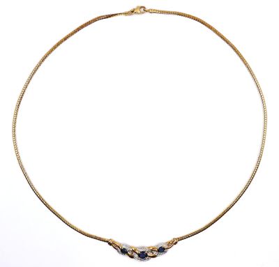 an image of a gold necklace with black stones on a white background