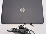 a dell laptop with a charger attached to it