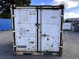 a white refrigerator sitting in the middle of a parking lot